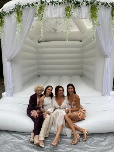 nevěsta se fotí s rodinou na svatebním nafukovacím hradu